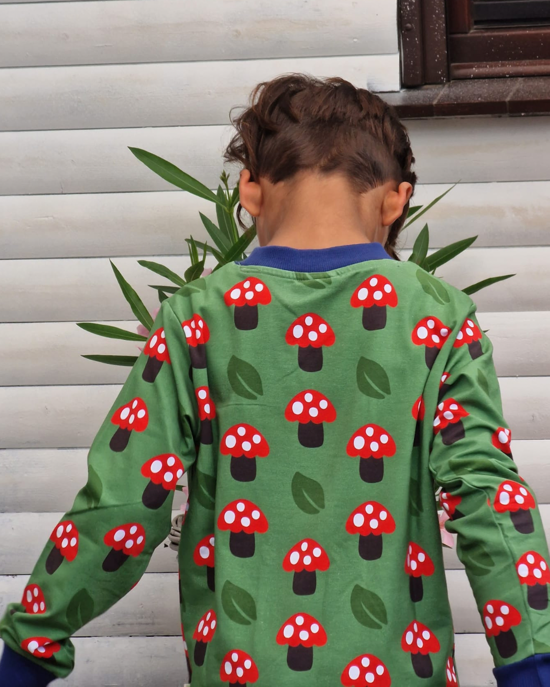 Vaikiškas džemperis iš GOTS sertifikuotos organinės medvilnės. Ryškiai žalios spalvos, margintas raudonais grybukais.